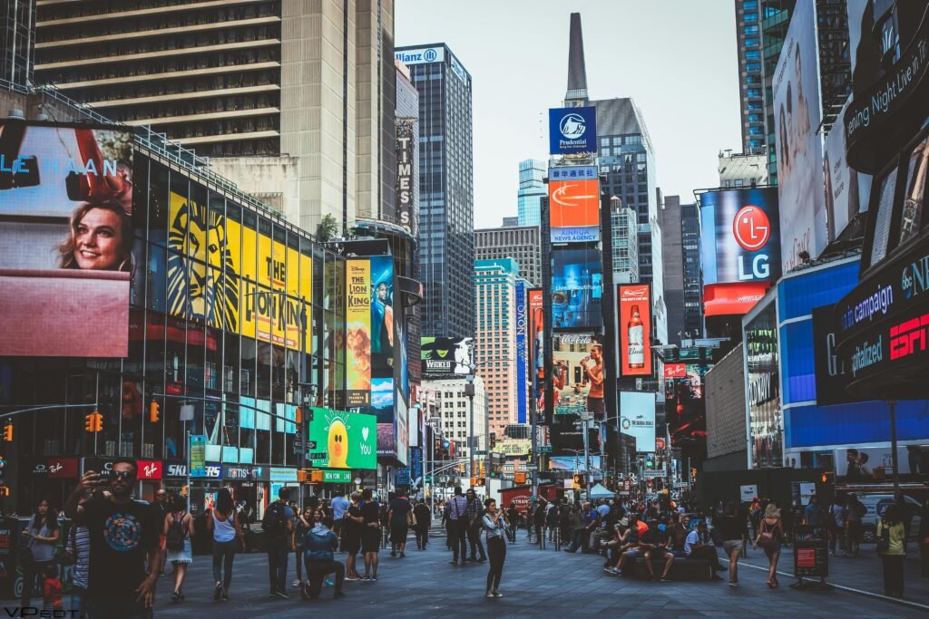 New York vs Tokyo: A Japan Traveler’s Thought on 2 Wonderful Cities 4 Bustling daytime view of Times Square with crowds, skyscrapers, and iconic billboards in New York City.