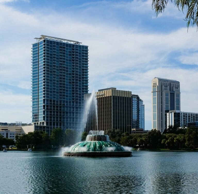Free Things to Do Near Orlando, Tampa & St. Pete (besides theme parks) 2 Skyline of Orlando featuring the famous Lake Eola fountain and modern skyscrapers.