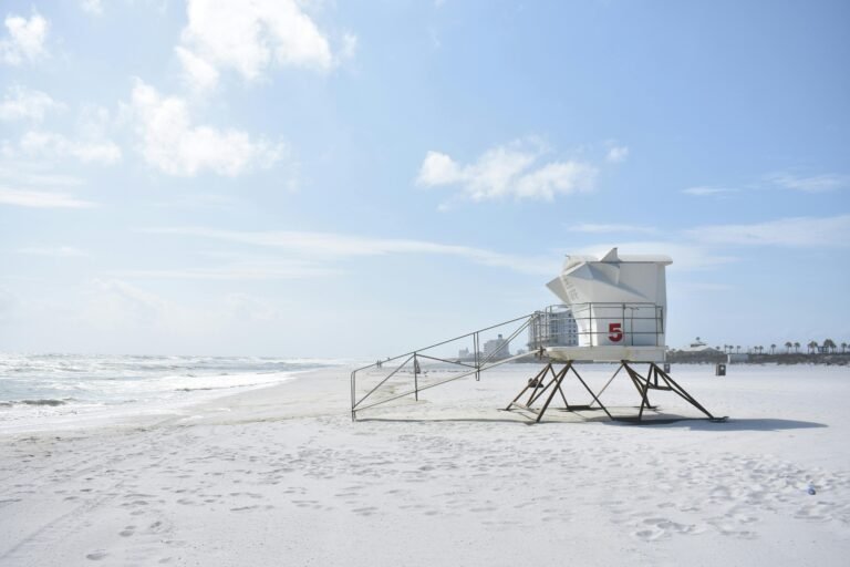 Free Things to Do Near Orlando, Tampa & St. Pete (besides theme parks) 10 Lifeguard tower overlooking a peaceful beach under a clear sky, perfect for summer relaxation.
