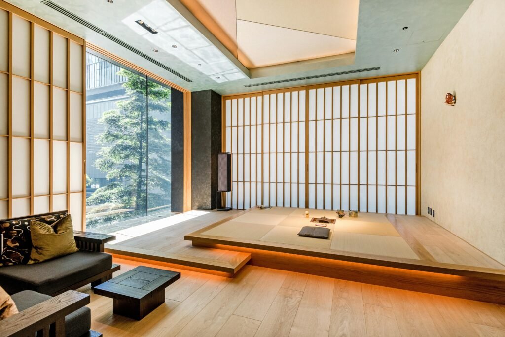 Why Japanese Remove Shoes Indoors (And Americans Don't): Cultural Guide 3 Bright and spacious Japanese living room featuring a modern tatami area and large windows with natural light.